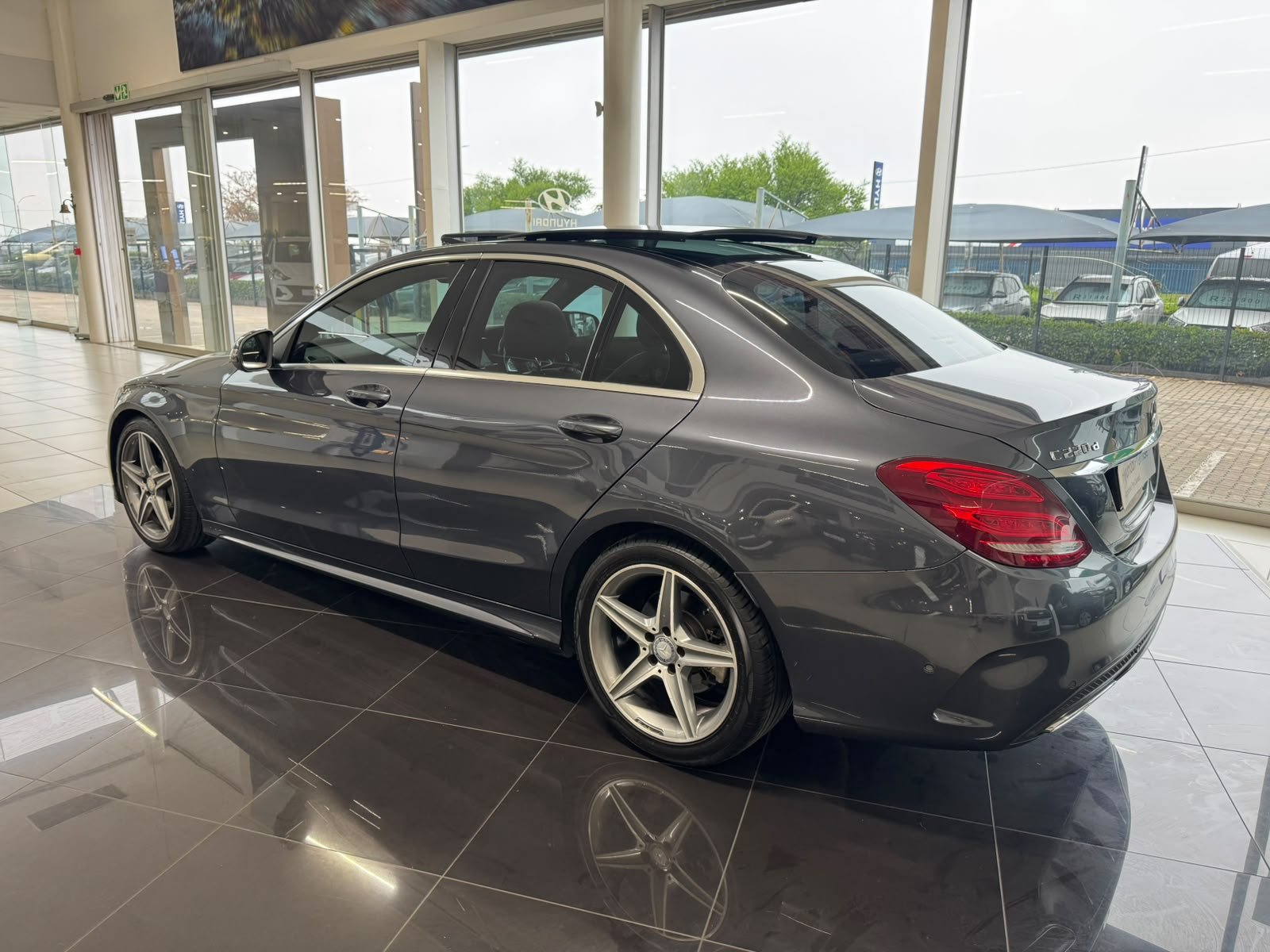 Grey Mercedes-Benz C-Class rear three-quarter view