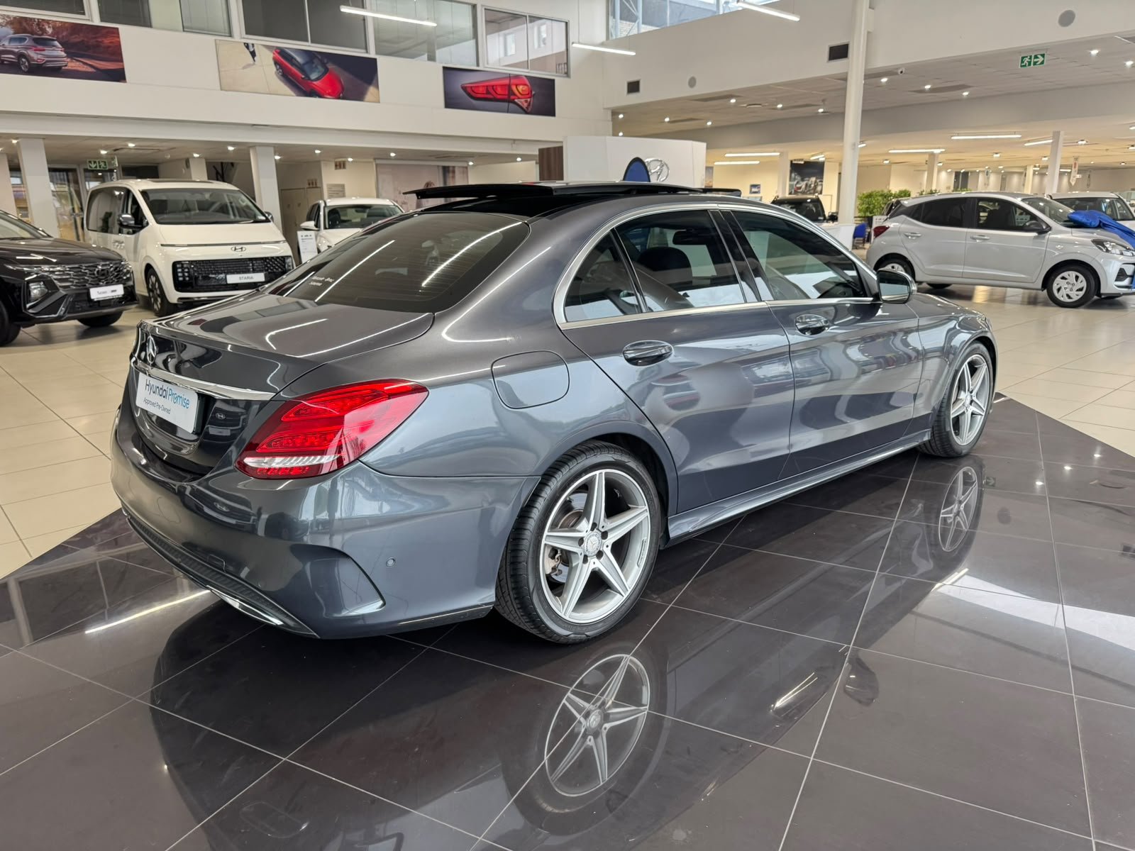 Grey Mercedes-Benz C-Class photographed from the rear side